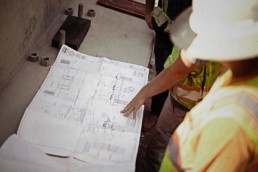 Crew looking at technical drawings