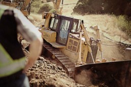 A bulldozer grading an embankment