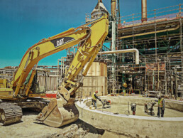 Construction equipment preparing tank foundation